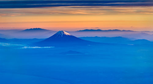 Scenic view of snowcapped mountain against cloudy sky