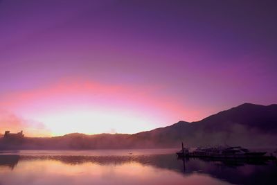 Scenic view of lake against sky during sunset