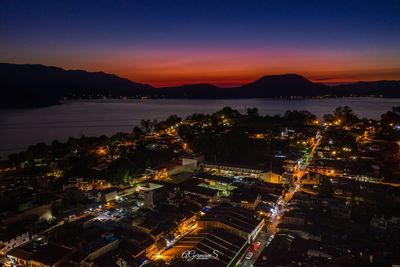 High angle view of illuminated city and buildings at night