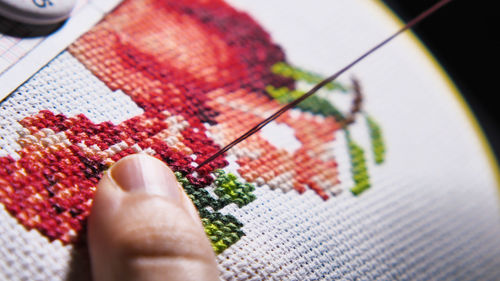 Cropped hand of person holding jigsaw piece
