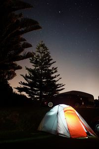 Tent on field against sky at night