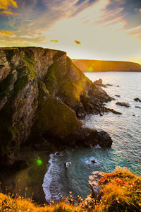 Scenic view of rocks at sunset