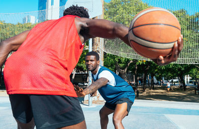 Midsection of man playing basketball