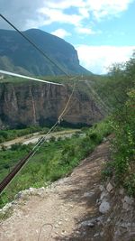 Road by mountain against sky
