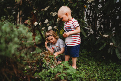 Full length of father and daughter on plants