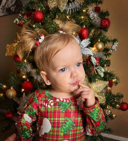 Cute girl decorating christmas tree