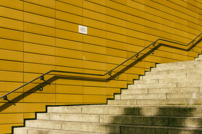 Empty steps by wall on sunny day