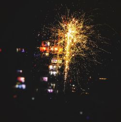 Low angle view of firework display at night