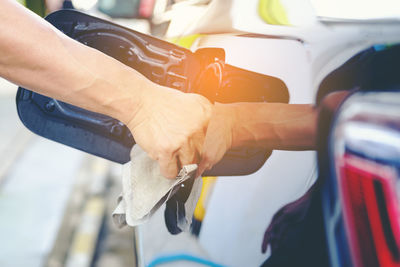 Close-up of hand feeling cleaning car