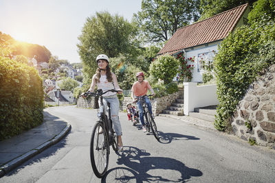 Germany, hamburg, blankenese, family riding e-bikes