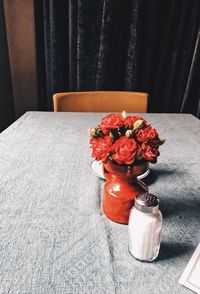 Close-up of flower vase on table at home