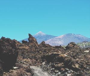 Scenic view of snowcapped mountains against clear blue sky