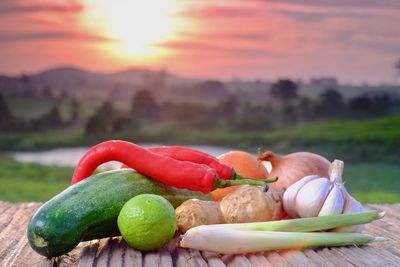 Close-up of fresh fruits against sky during sunset