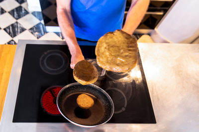 Cooking vegan seitan burgers flying in the air with selective focus