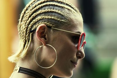 Close-up of young woman in sunglasses looking away