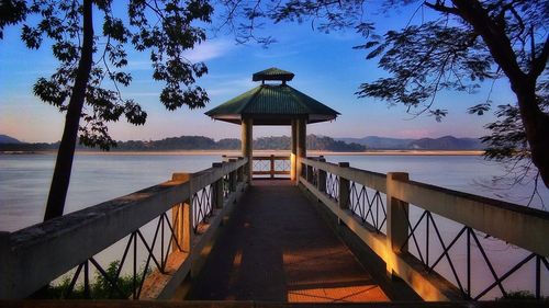 Gazebo by sea against sky