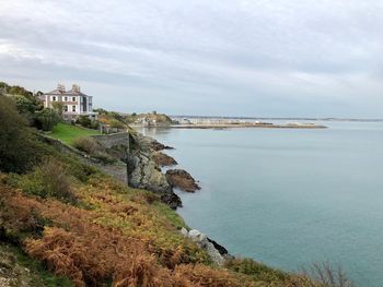 Scenic view of sea and buildings against sky