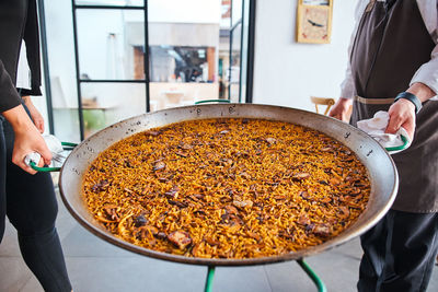 Midsection of man preparing food in kitchen