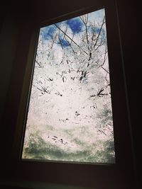 Close-up of glass window against sky