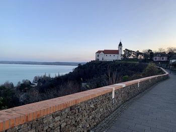 View of building by sea against sky