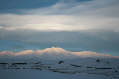 Scenic view of snow mountains against sky