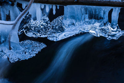 Icicles hanging from a branch in the stream