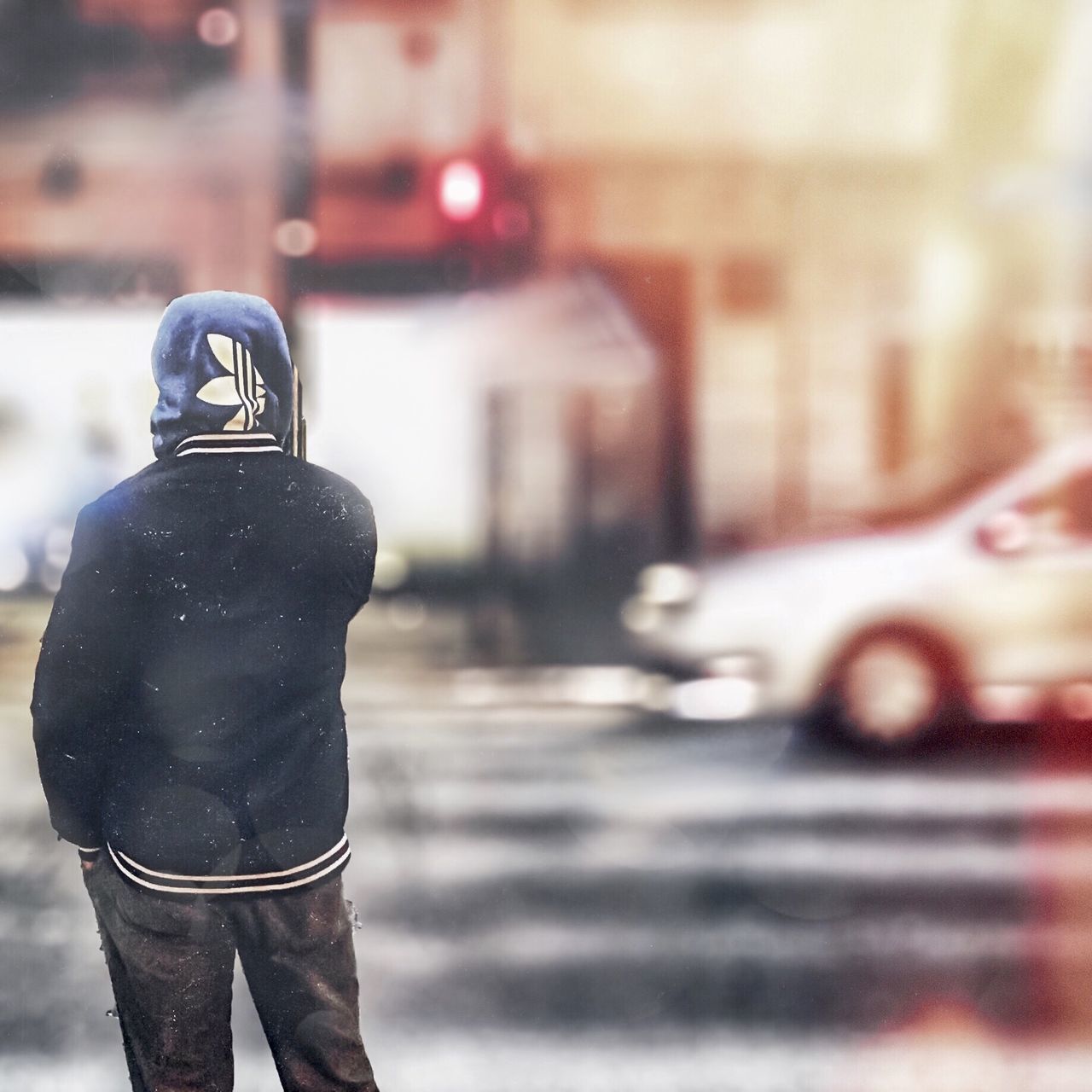 REAR VIEW OF MAN STANDING ON ROAD