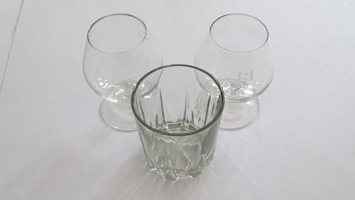 High angle view of glasses on white table