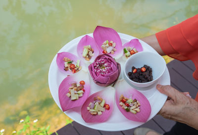 High angle view of person holding breakfast on table