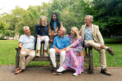 Group of friends sitting on field