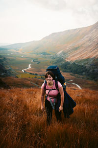 Full length of woman sitting on land