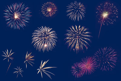 Low angle view of firework display at night