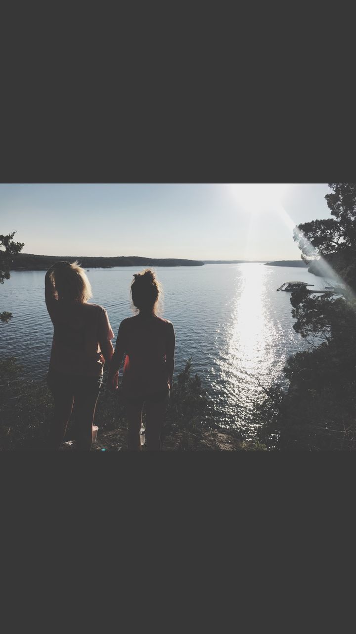 water, sea, togetherness, sky, real people, two people, child, leisure activity, family, women, silhouette, nature, beach, horizon over water, land, lifestyles, standing, bonding, childhood, positive emotion, outdoors, sister