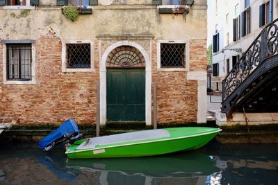 Boats in canal against building