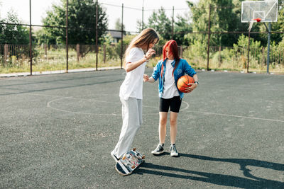 Two friends are learning to skate, the girls help each other and support each other. friends