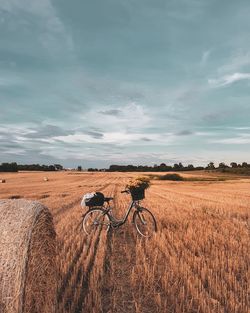 Bicycle on field against sky