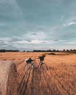 Bicycle on field against sky