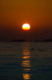 Scenic view of sea against romantic sky at sunset