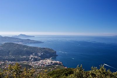 High angle view of sea and cityscape against sky