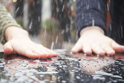 Close-up of hands on table