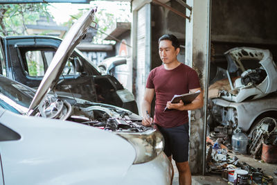 Side view of man driving car