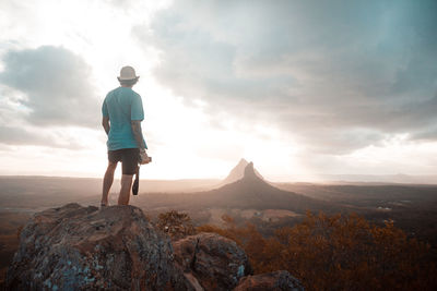 Rear view of man standing on rock