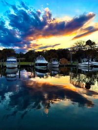 Reflection of clouds in sea at sunset