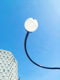 Low angle view of street light against clear blue sky