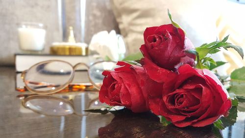 Close-up of red rose on table