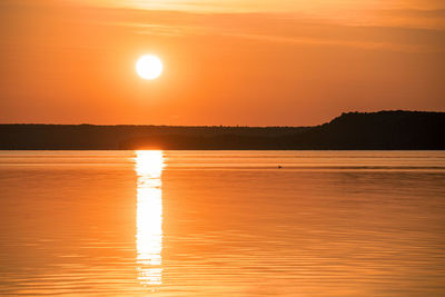 Scenic view of sea against orange sky