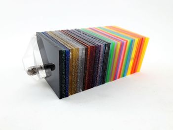 High angle view of multi colored pencils on table against white background