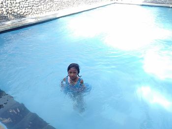 Portrait of young man swimming in pool