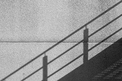 Shadow of railing on wall