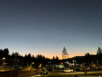 Cars on road against sky at night